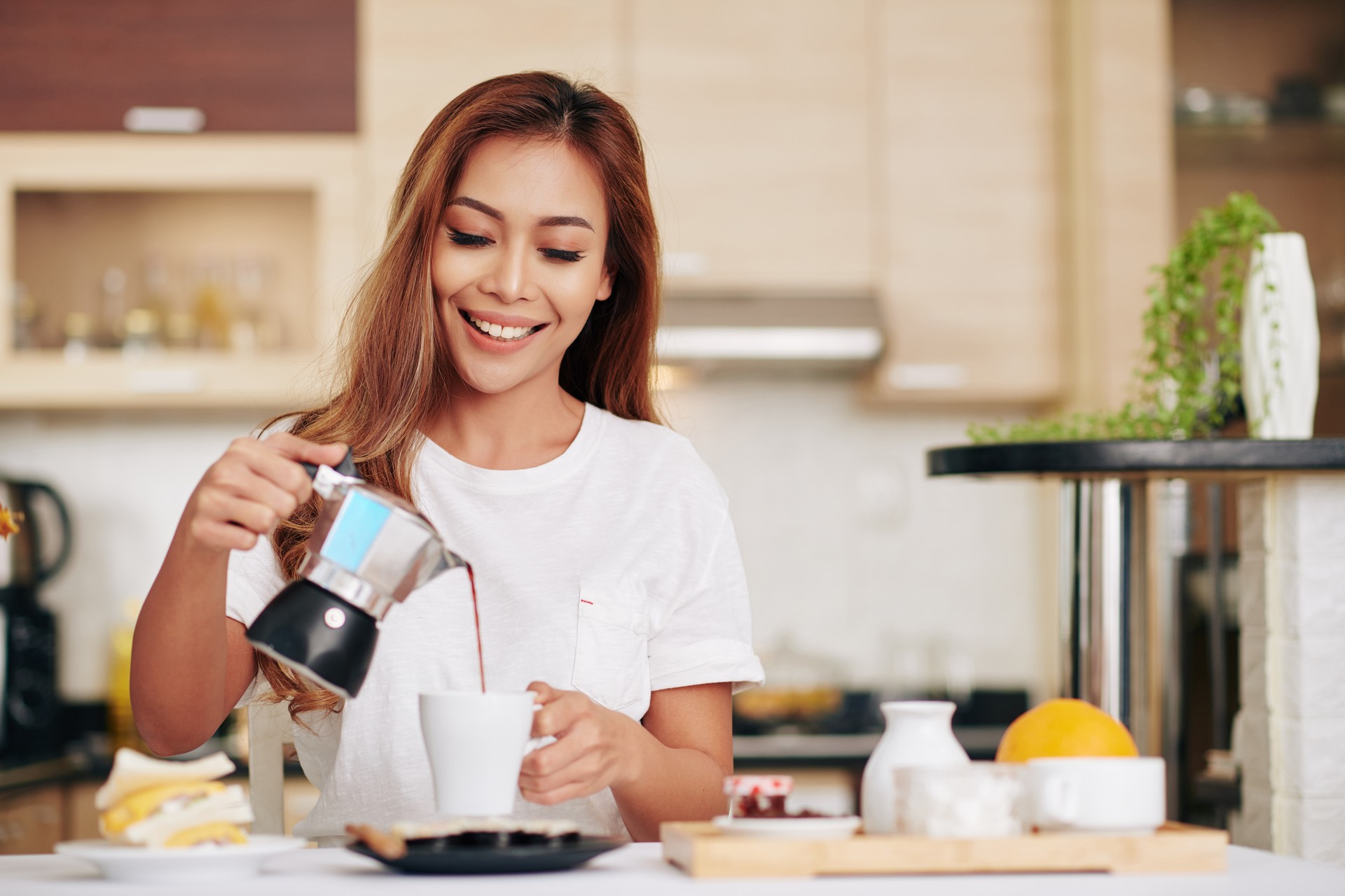 Woman pouring herself coffee