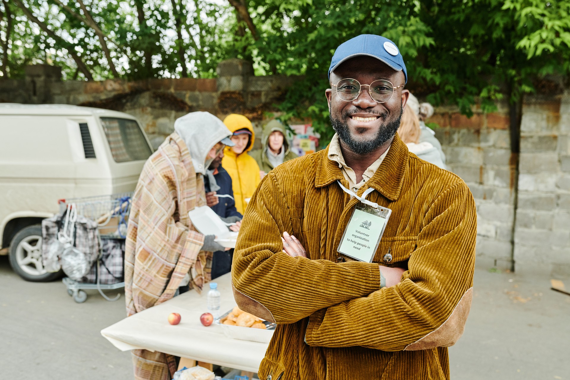 Volunteer helping homeless people outdoors