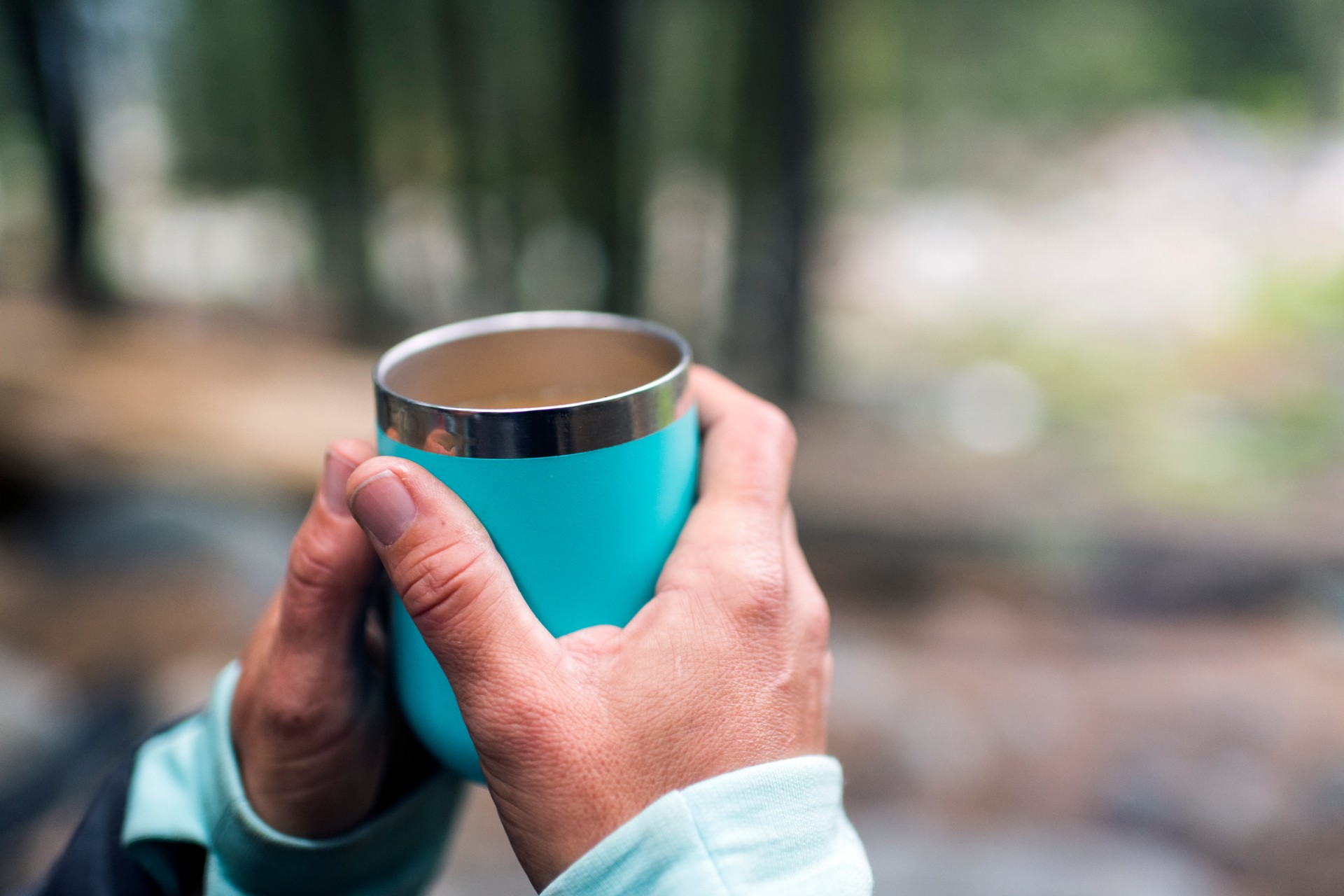 Female hands holding thermo mug